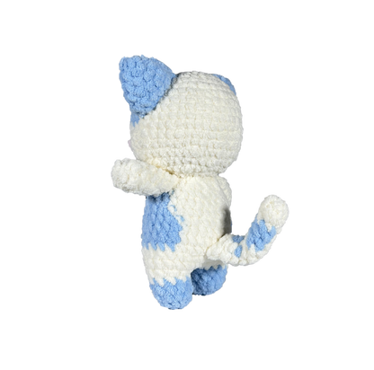 Blue and white crochet cat standing on 2 legs facing to the side.