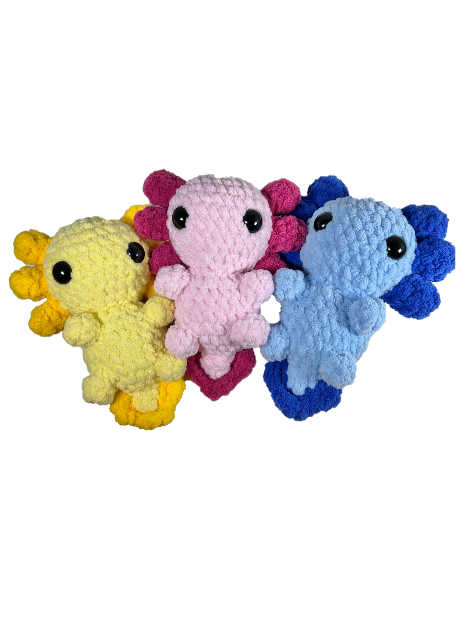 Three crochet axolotl standing next to each other with the colors yellow, pink, and blue.