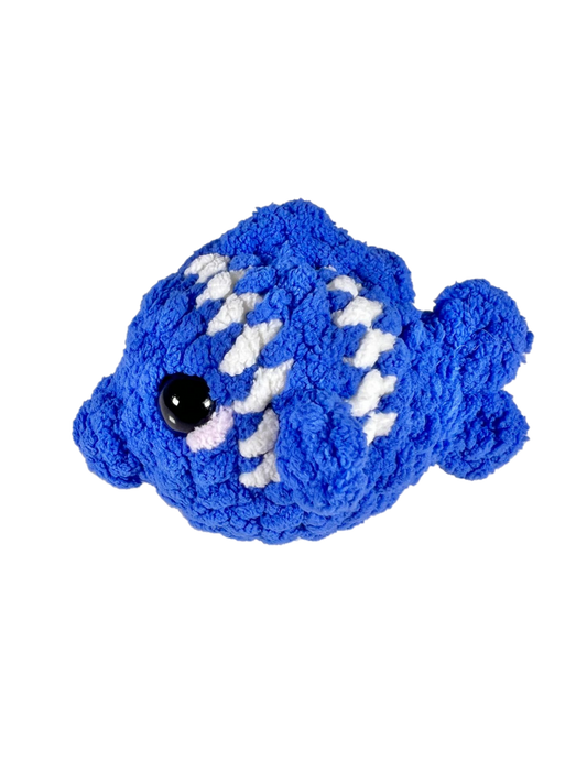 Blue crochet fish plushie with 2 white stripes facing left.