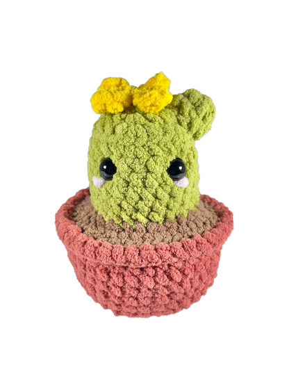 Crochet cactus plushie in a brown pot plushie with a yellow crochet flower on top.