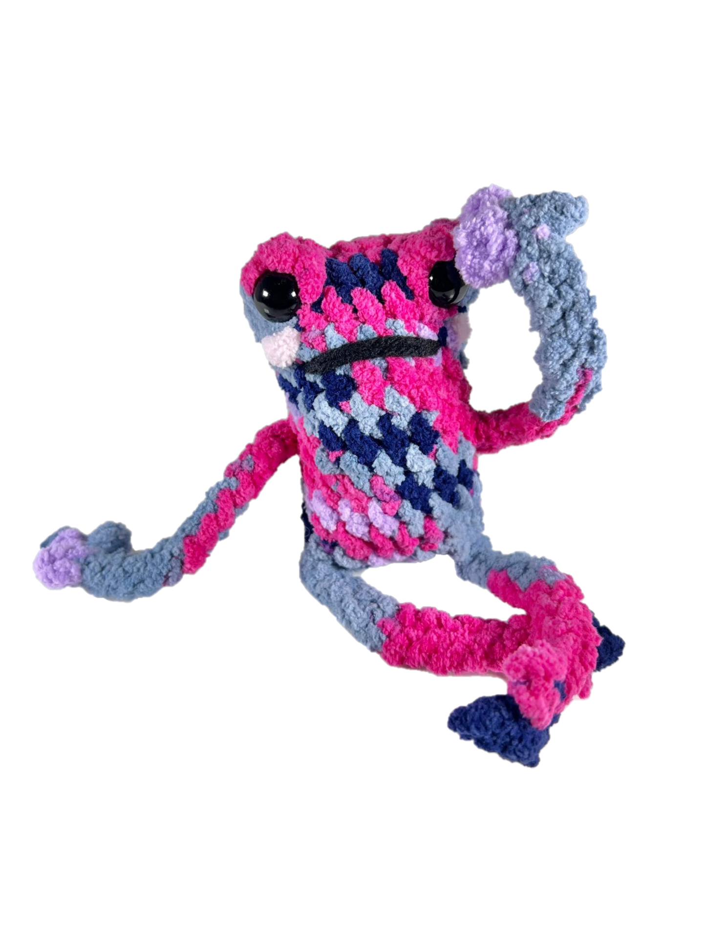 Dramatic multicolored crochet frog plushie in dramatic pose.