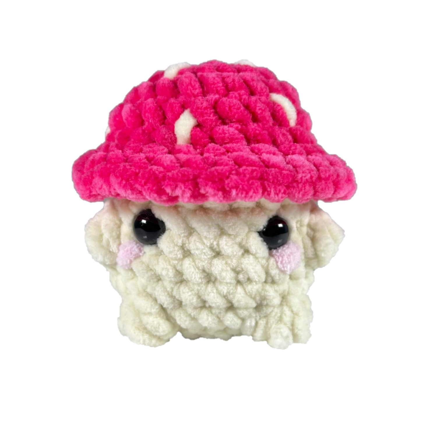 Pink crochet mushroom sitting looking forward.