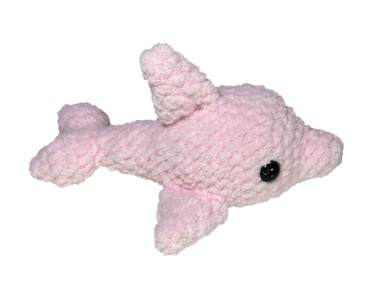 Pink crochet dolphin looking to the right.