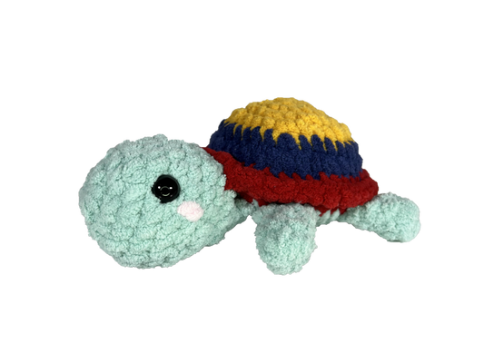 Green blushing turtle with the Colombian flag yellow, blue, and red colors on the shell.