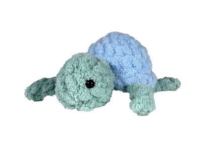 Green crochet turtle with a blue shell.