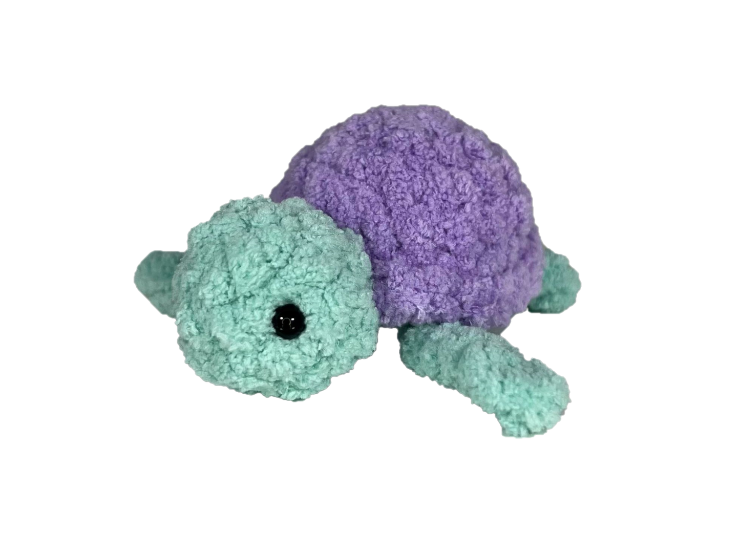 Green crochet turtle with a purple shell.