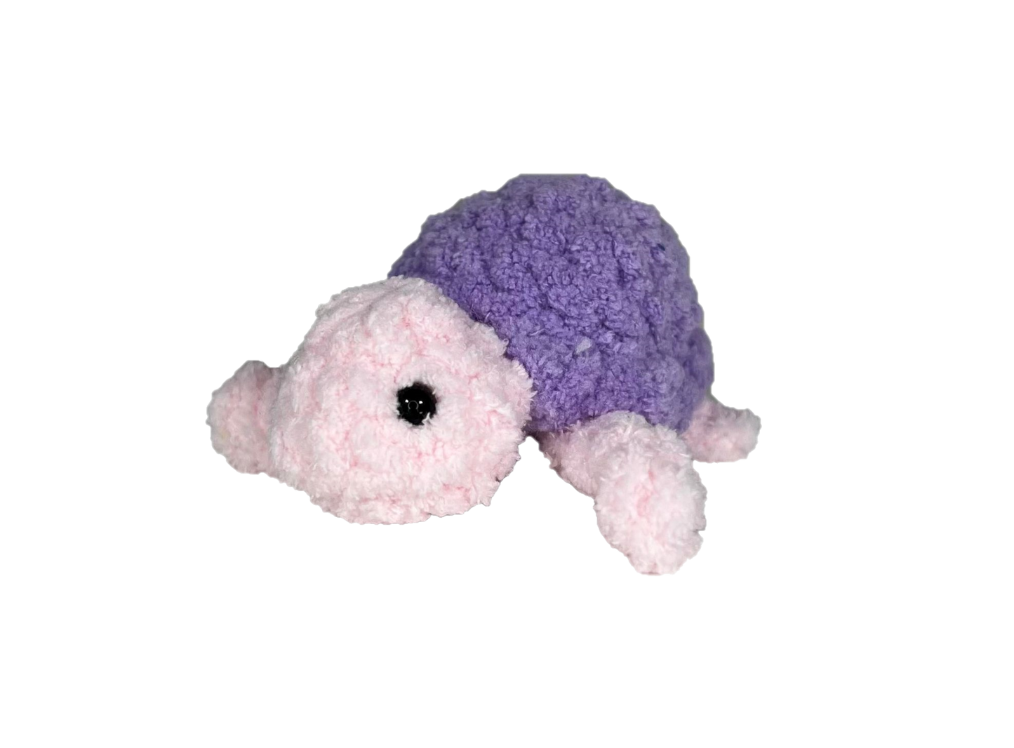 Pink crochet turtle with a purple shell.