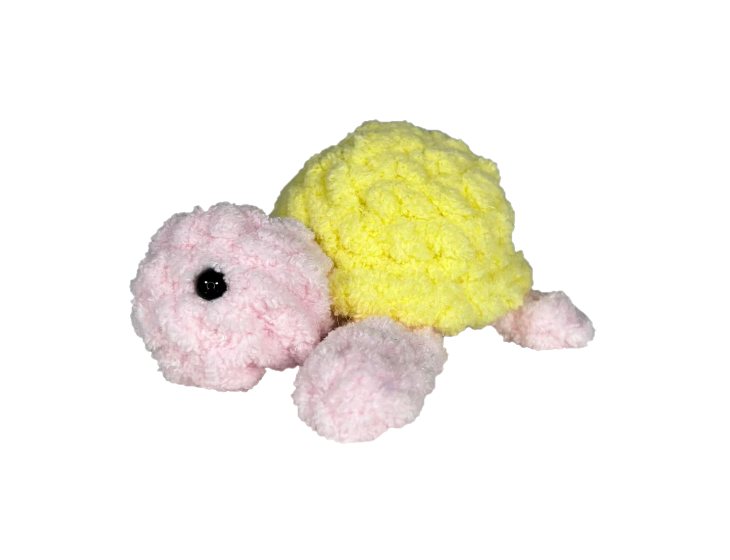 Pink crochet turtle with a yellow shell.